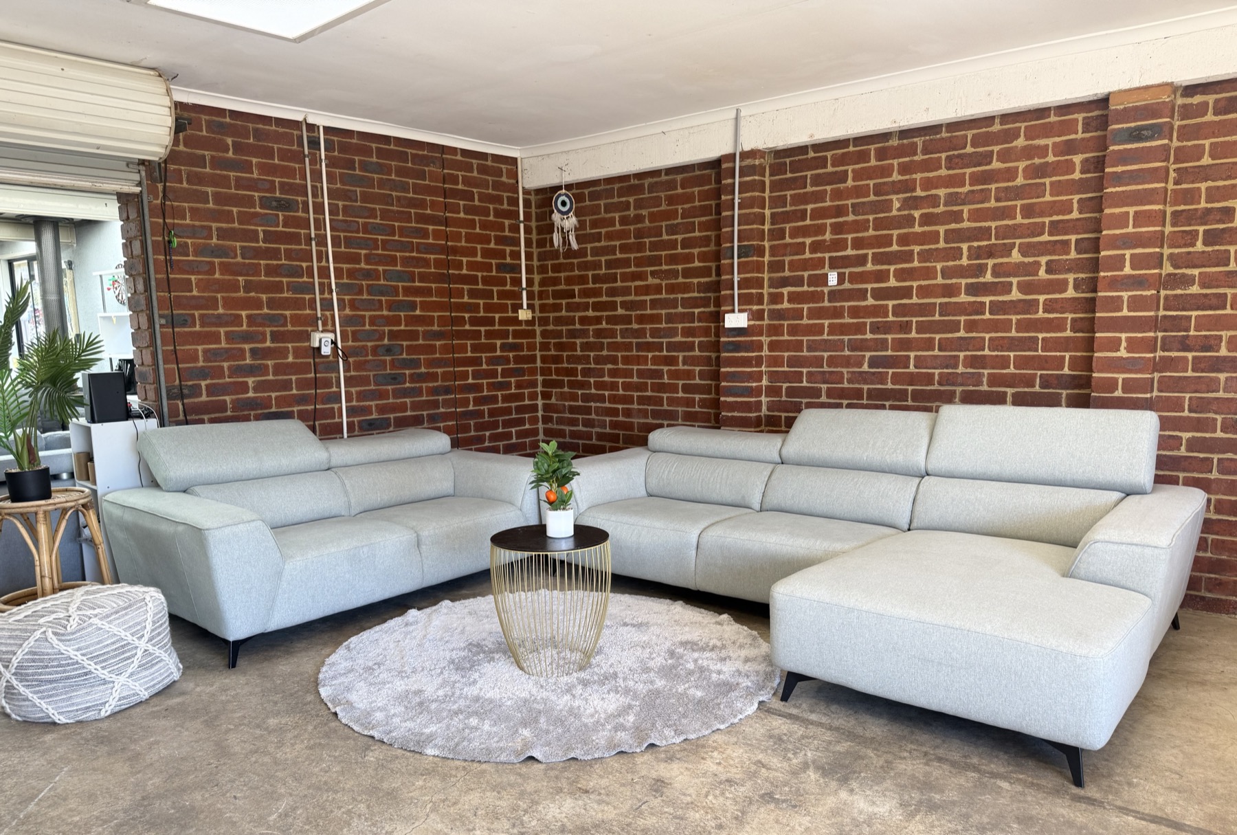 Light grey corner lounge displayed in the private showroom